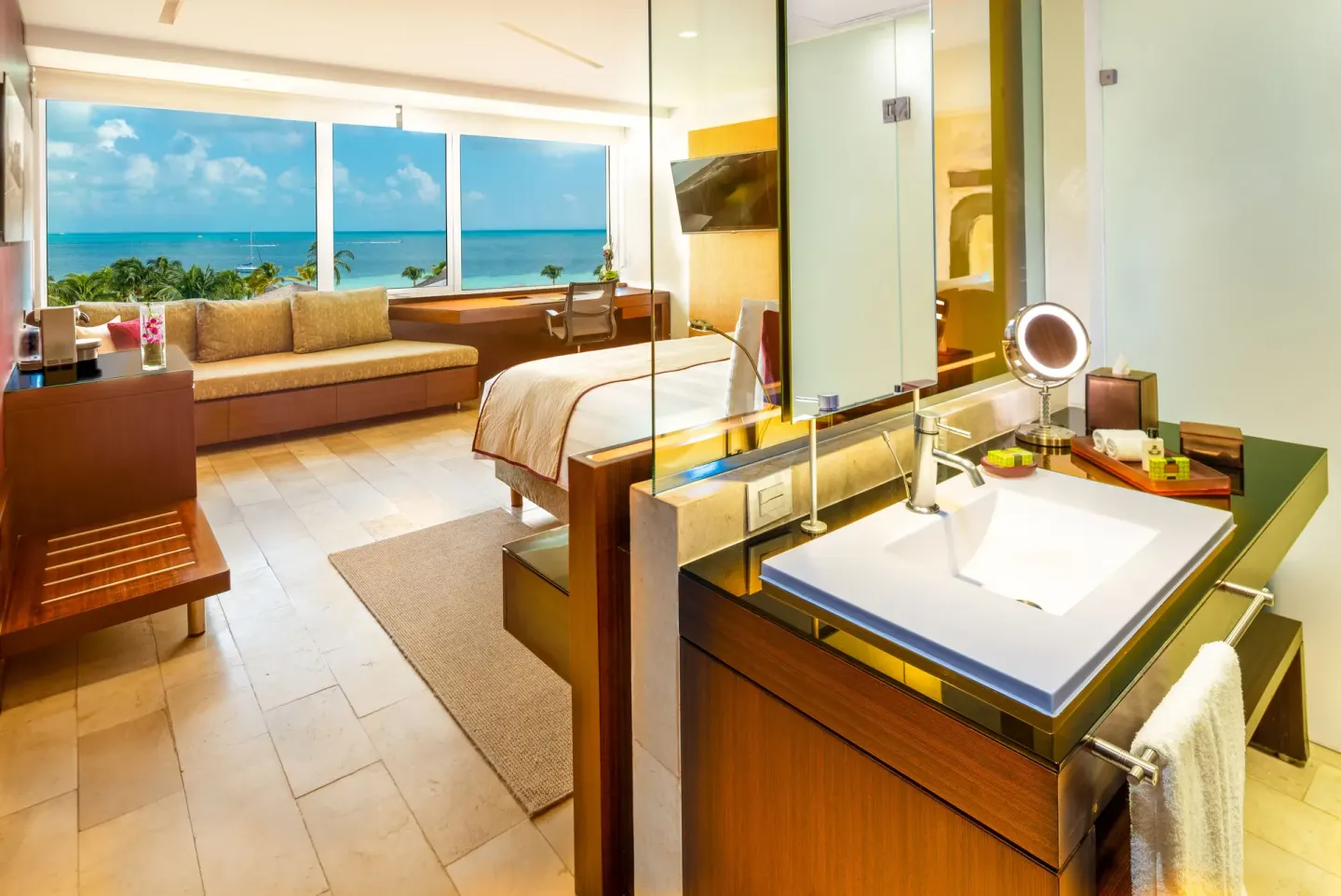 Ocean view guest room with king bed and open vanity at InterContinental Presidente Cancun Resort.