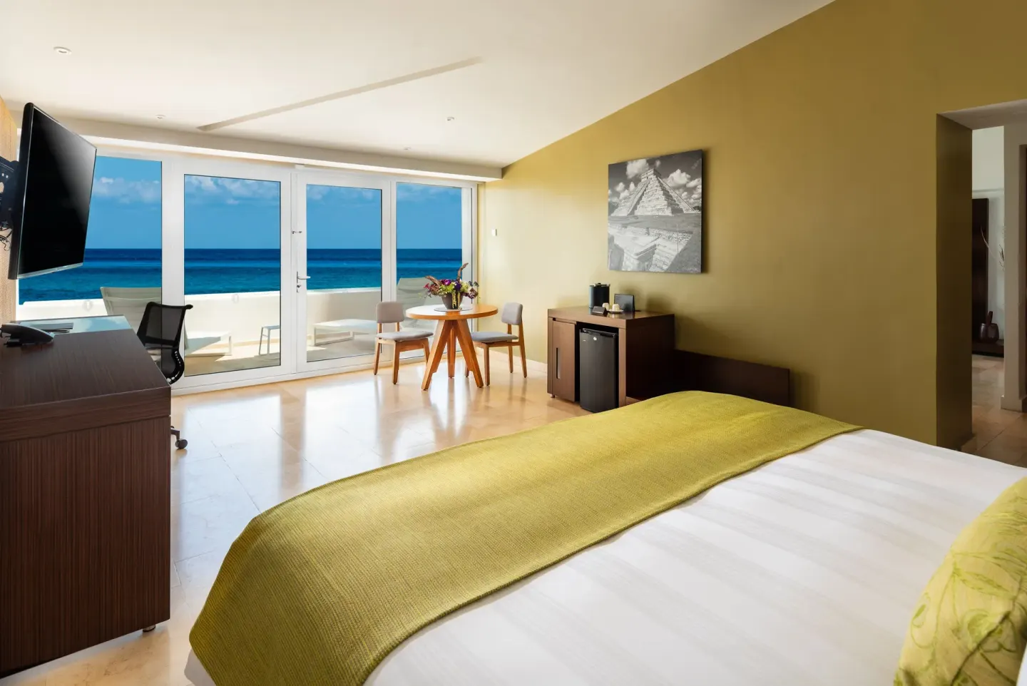 Oceanfront king guest room with balcony at InterContinental Presidente Cancun Resort.