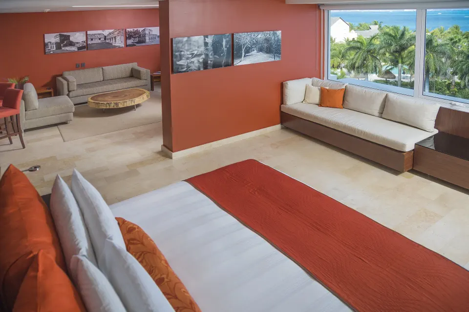 Suite bedroom and sitting area with palm view at InterContinental Presidente Cancun Resort.