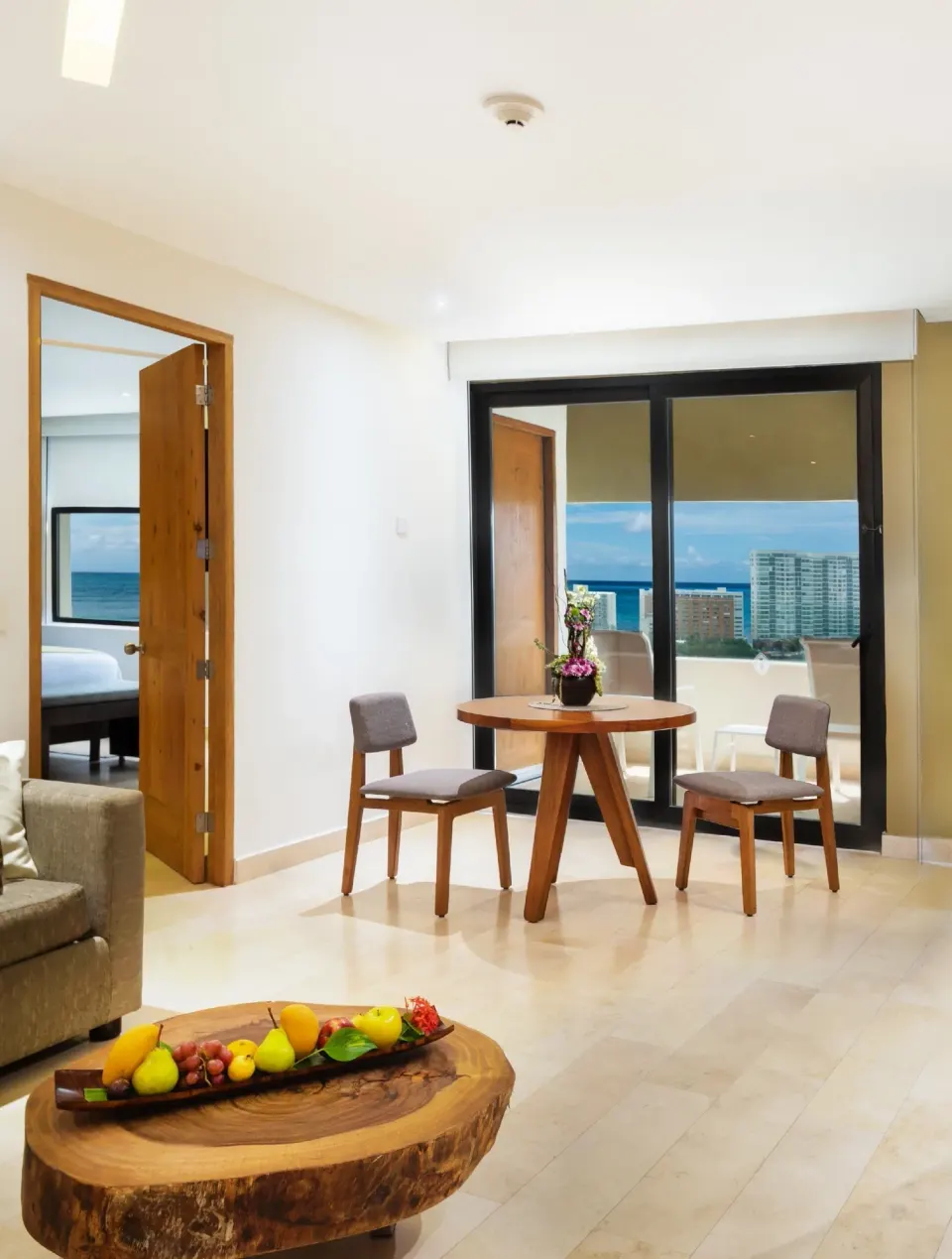 Suite sitting area with balcony and ocean view at InterContinental Presidente Cancun Resort.