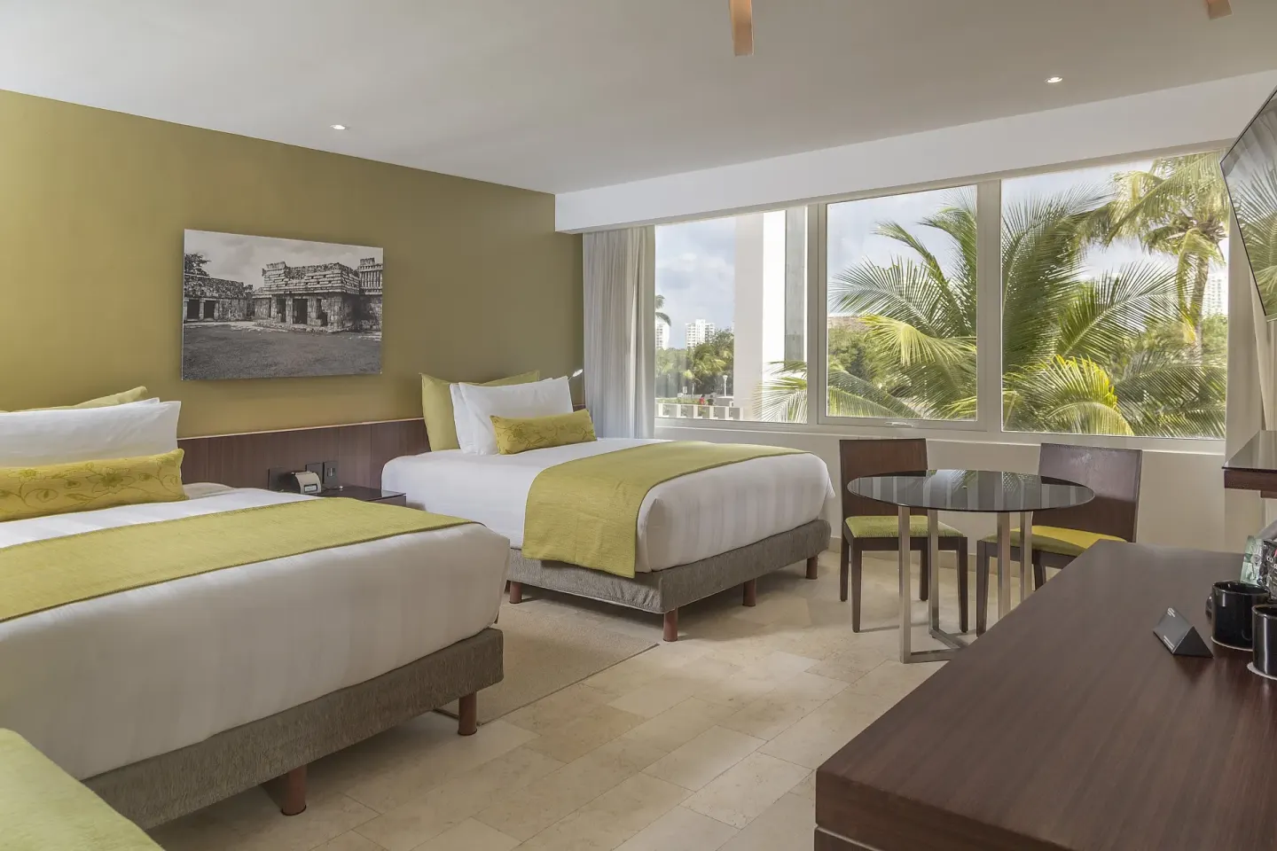 Two-bed guest room with palm view at InterContinental Presidente Cancun Resort.