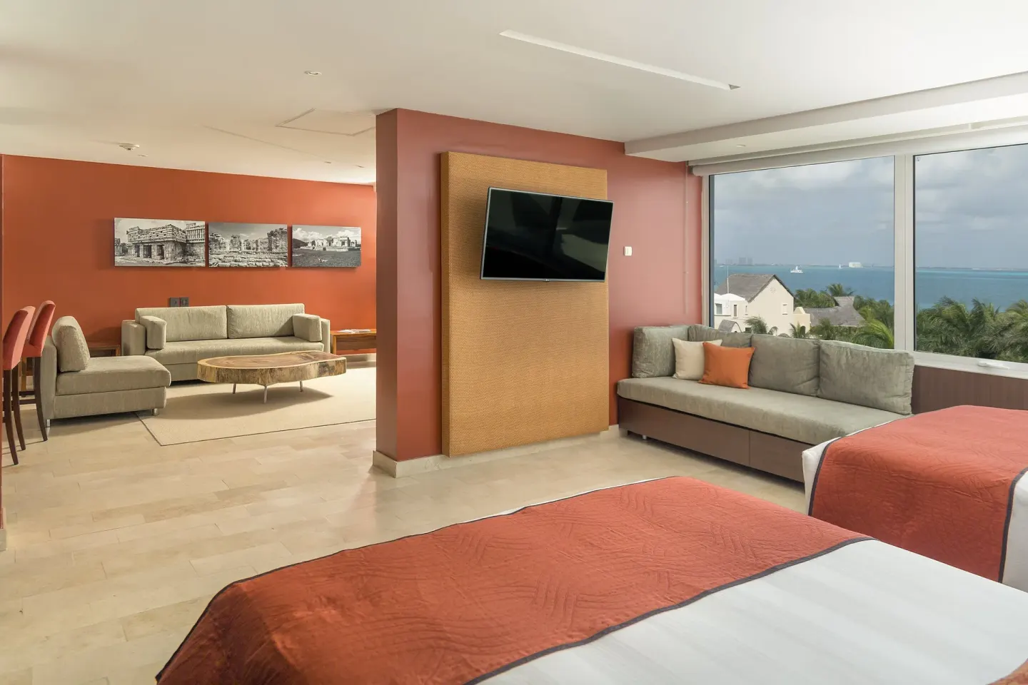 Two-bed suite with sitting area and lagoon view at InterContinental Presidente Cancun Resort.