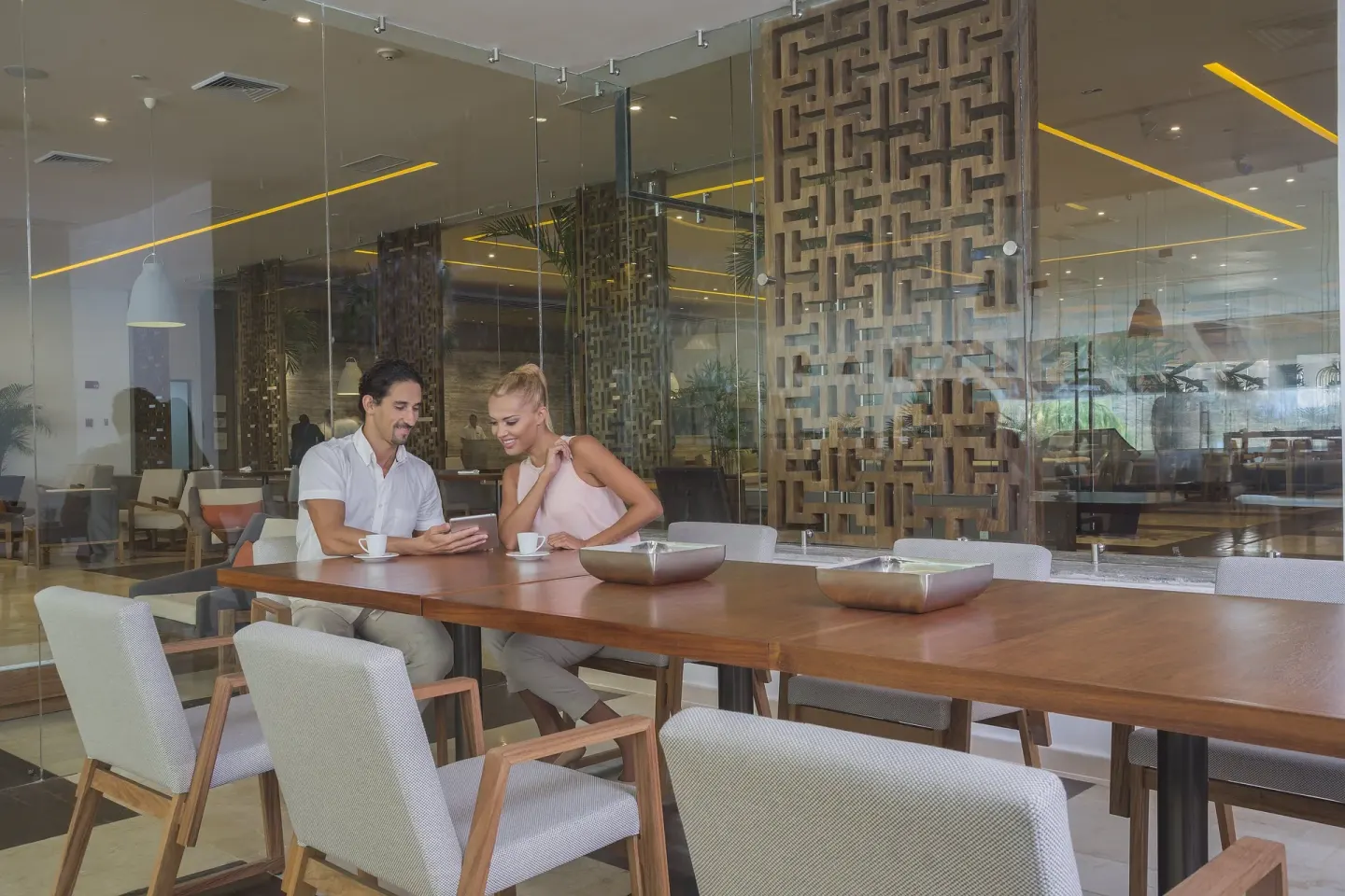 Cafe-style seating by glass walls at InterContinental Presidente Cancun Resort.