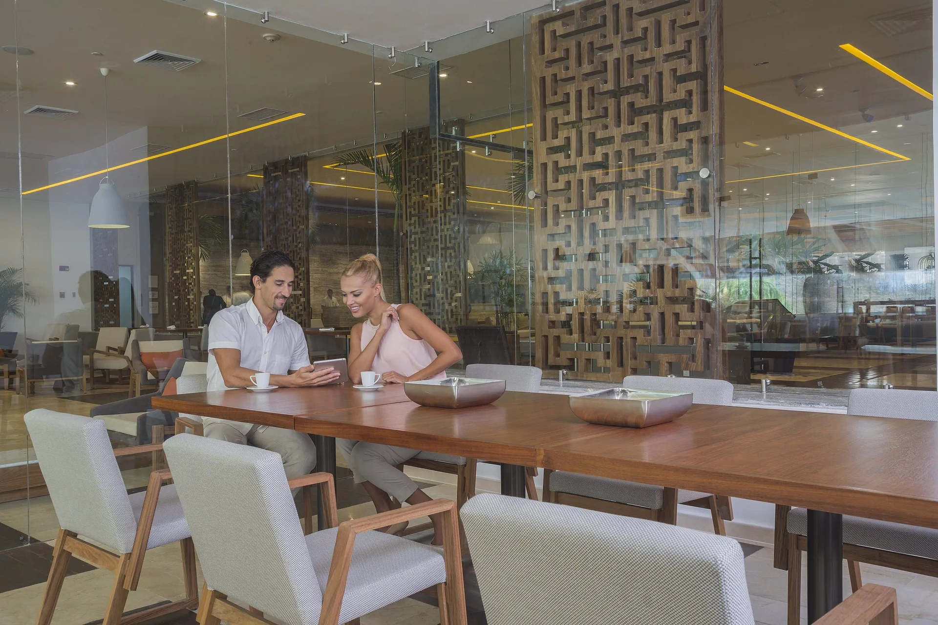 Cafe-style seating by glass walls at InterContinental Presidente Cancun Resort.