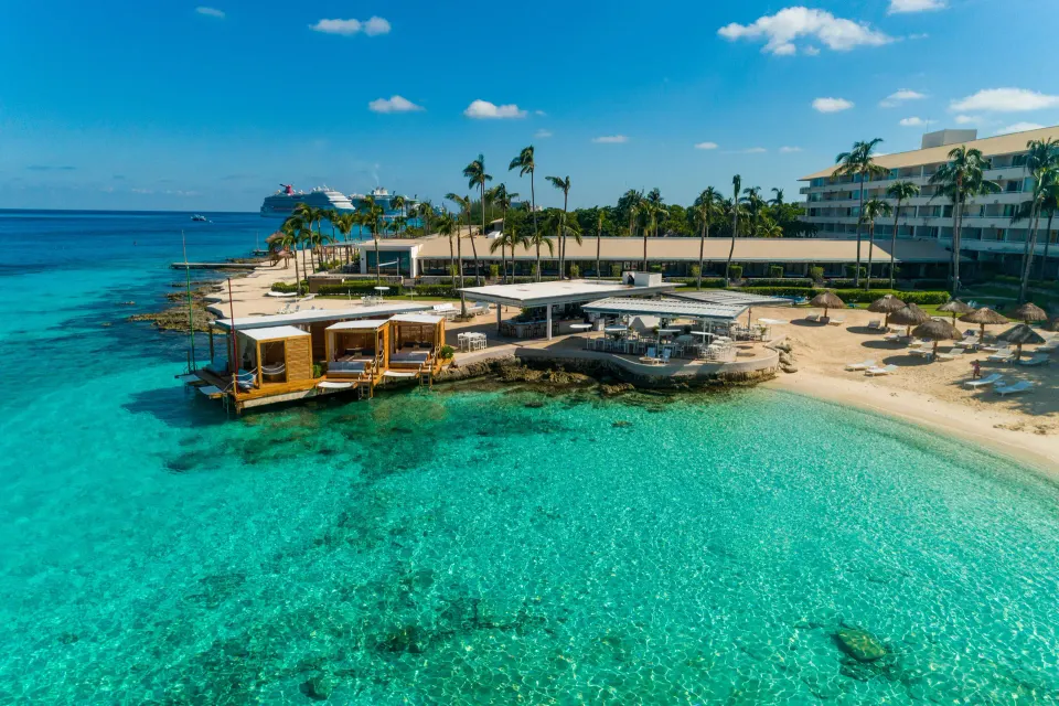 Aerial daytime view of the resort coastline, beach cabanas, and turquoise bay at InterContinental Presidente Cozumel Resort S