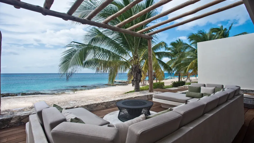 Shaded beachfront terrace with sectional sofa beside the sea at InterContinental Presidente Cozumel Resort Spa