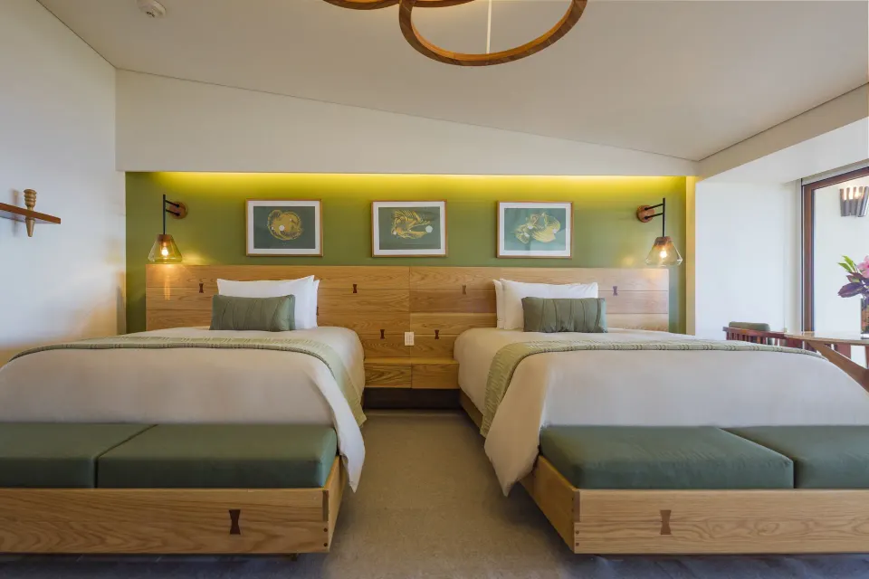 Guest room with two twin beds and green accent wall at InterContinental Presidente Cozumel Resort Spa