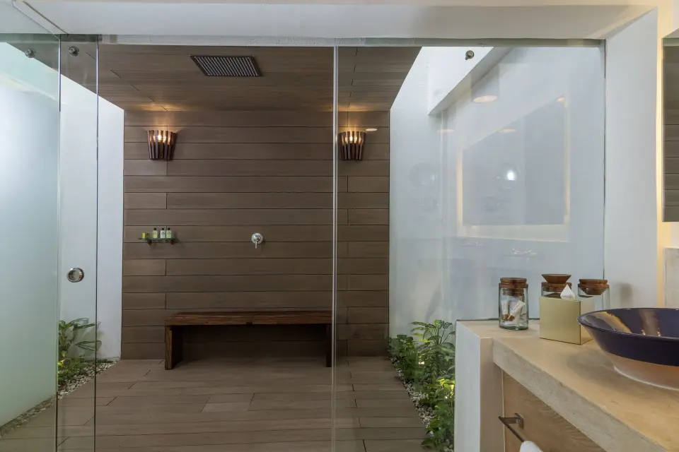 Glass-enclosed shower courtyard and bench at InterContinental Presidente Cozumel Resort Spa