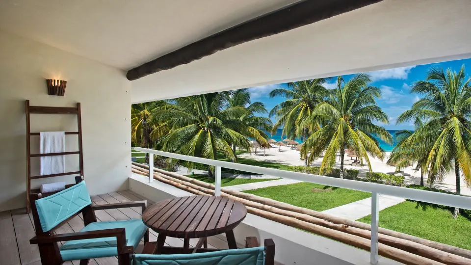 Balcony seating with small table and palm-lined beach view at InterContinental Presidente Cozumel Resort Spa