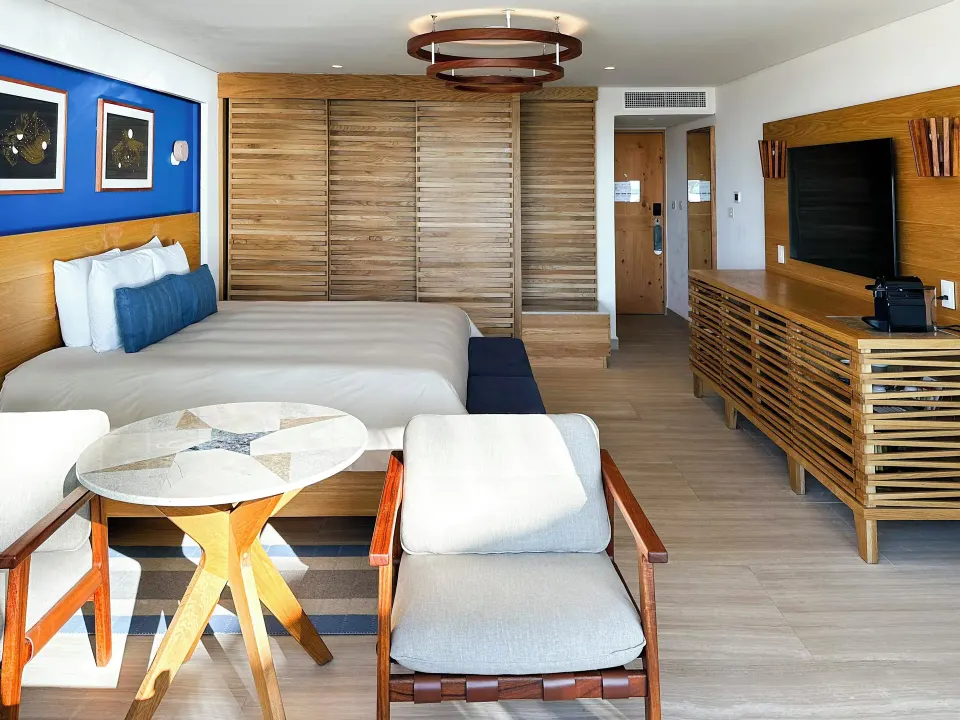 Bright junior suite with king bed and seating area at InterContinental Presidente Cozumel Resort Spa