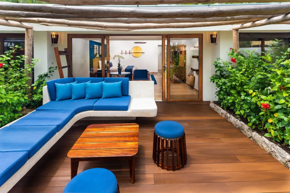 L-shaped outdoor lounge with blue cushions and tropical plants at InterContinental Presidente Cozumel Resort Spa