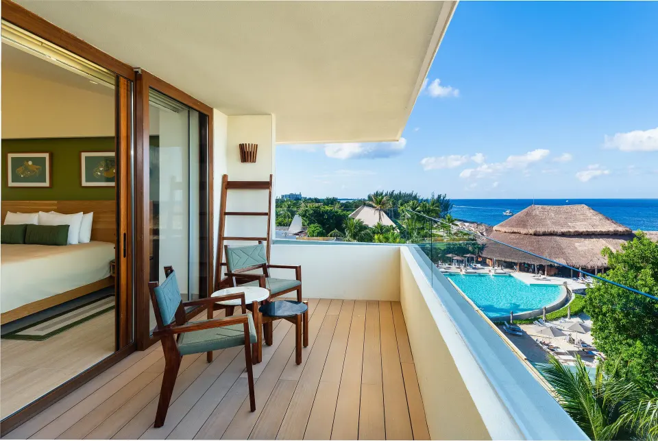 Balcony with chairs overlooking pool and ocean at InterContinental Presidente Cozumel Resort Spa