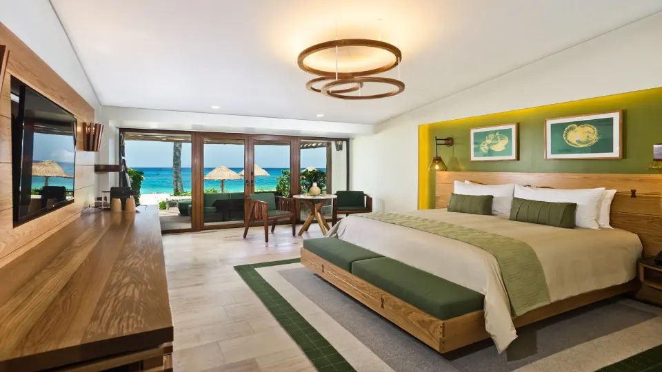 King bed guest room with green accents and ocean view at InterContinental Presidente Cozumel Resort Spa