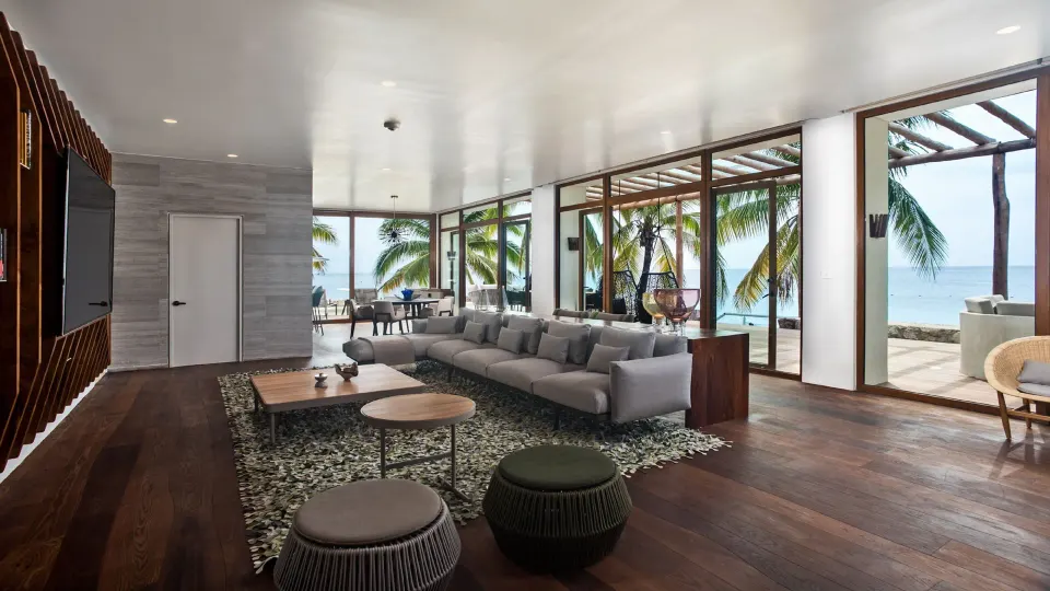 Open lobby lounge with sofas and floor-to-ceiling windows facing the sea at InterContinental Presidente Cozumel Resort Spa