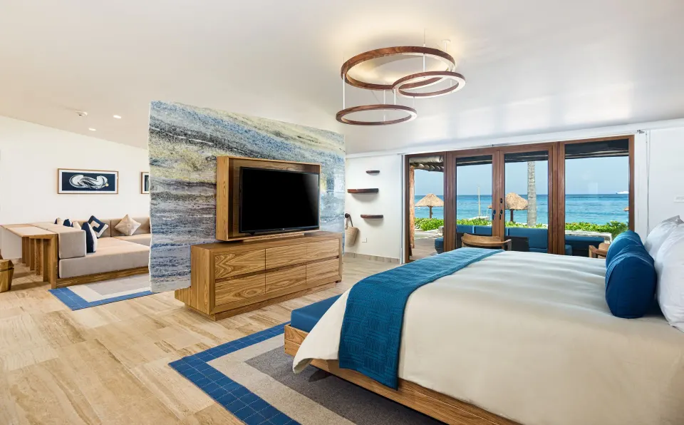 Large suite bedroom with TV divider and ocean view at InterContinental Presidente Cozumel Resort Spa