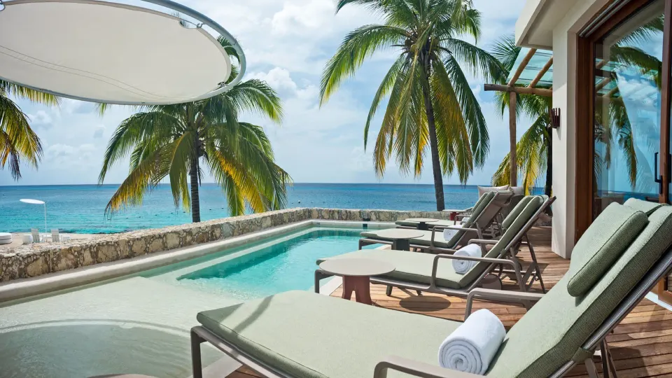 Sun loungers beside a private plunge pool and ocean at InterContinental Presidente Cozumel Resort Spa