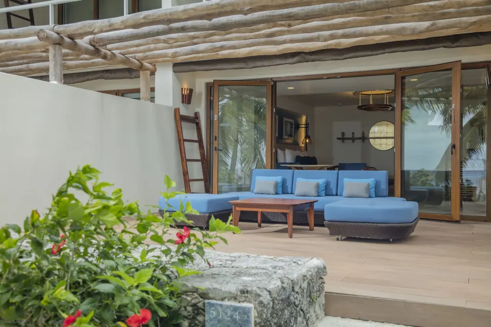 Outdoor patio seating with blue sofa at InterContinental Presidente Cozumel Resort Spa