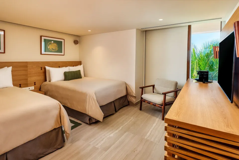 Compact twin guest room with TV and partial garden view at InterContinental Presidente Cozumel Resort Spa
