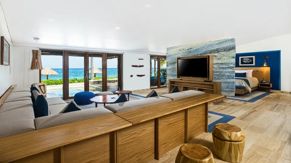 Spacious suite living area with television and ocean view at InterContinental Presidente Cozumel Resort Spa