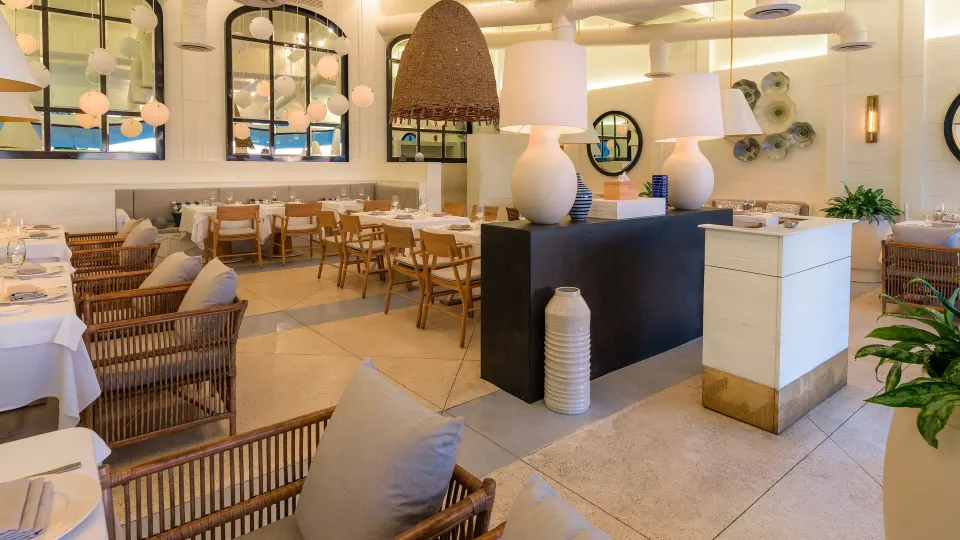 Bright indoor dining room with wicker chairs at InterContinental Presidente Cozumel Resort Spa
