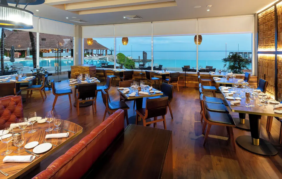 Interior dining room with wood floors and ocean views at InterContinental Presidente Cozumel Resort Spa