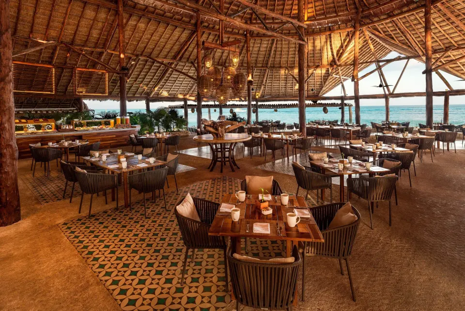 Large palapa dining room with tables and ocean view at InterContinental Presidente Cozumel Resort Spa