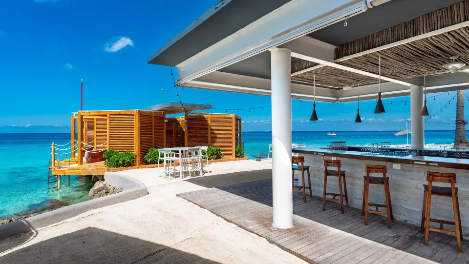Open-air ocean bar with stools and cabana decks at InterContinental Presidente Cozumel Resort Spa