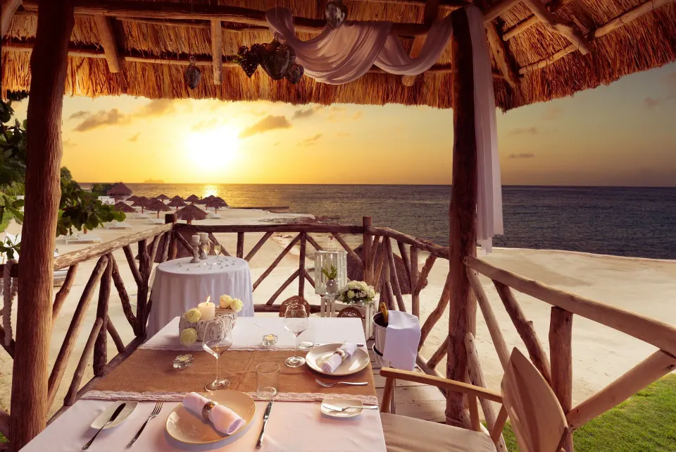 Sunset table for two under a palapa at InterContinental Presidente Cozumel Resort Spa