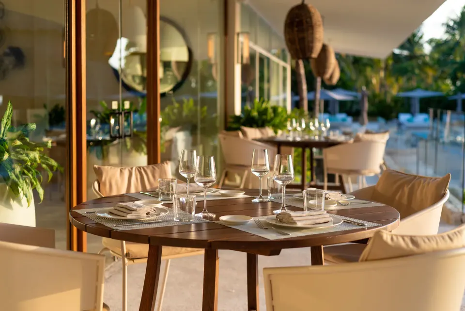 Round table with glassware by a poolside terrace at InterContinental Presidente Cozumel Resort Spa