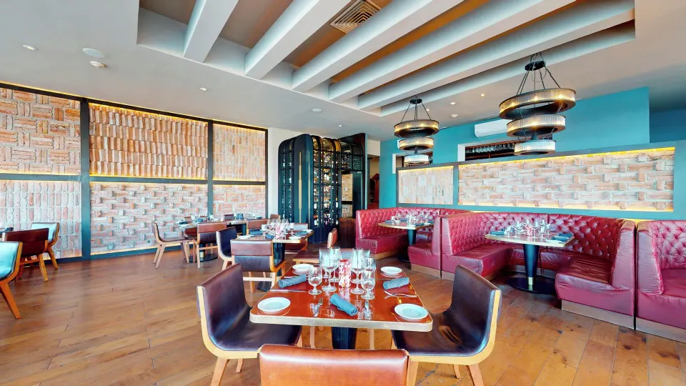 Restaurant interior with tables set and leather chairs at InterContinental Presidente Cozumel Resort Spa