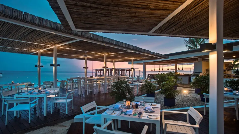 Outdoor seaside dining terrace with white tables at InterContinental Presidente Cozumel Resort Spa