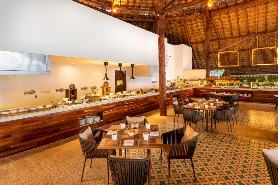Thatched-roof buffet dining area with wooden counters at InterContinental Presidente Cozumel Resort Spa
