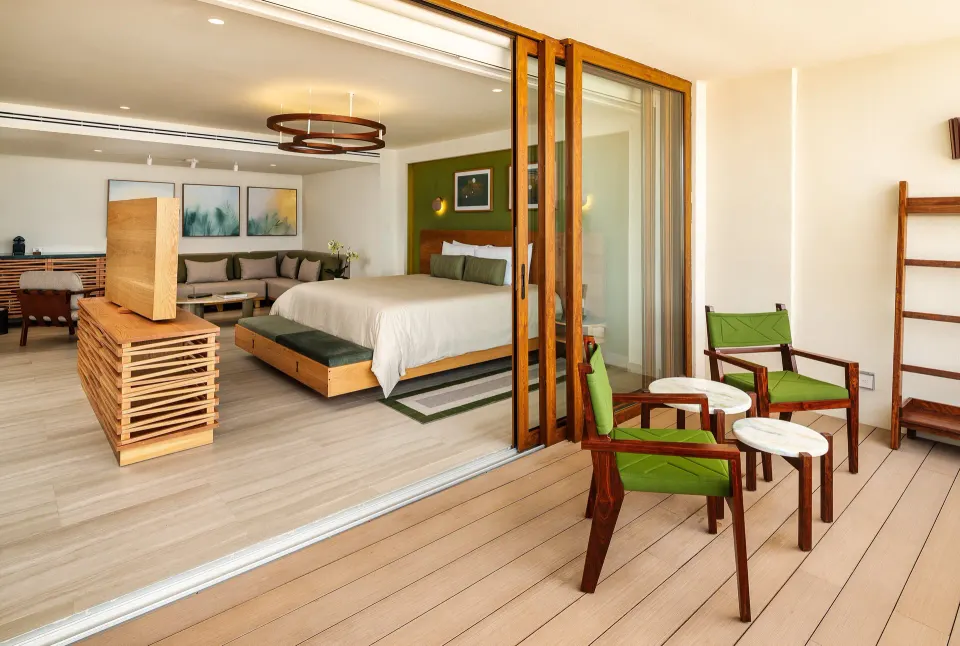 Junior Suite balcony entrance with seating and king bed inside at InterContinental Presidente Cozumel Resort Spa