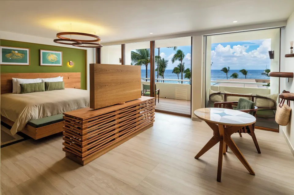 Junior Suite interior with king bed and ocean view at InterContinental Presidente Cozumel Resort Spa