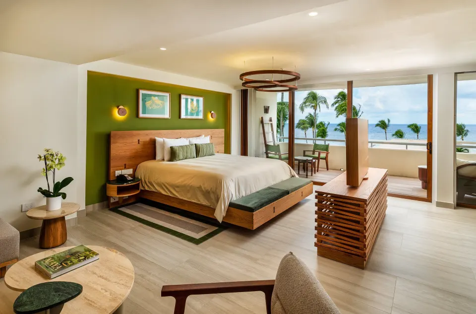 Junior Suite ocean-view bedroom with seating and balcony at InterContinental Presidente Cozumel Resort Spa