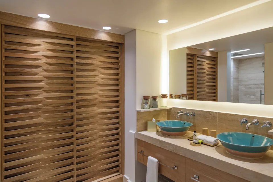 Bathroom double sinks and wooden cabinetry in Premium Ocean View room at InterContinental Presidente Cozumel Resort Spa