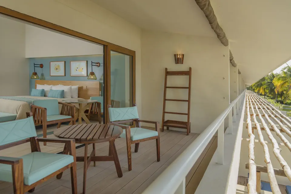 Long balcony with outdoor seating and sliding doors to Premium Ocean View room at InterContinental Presidente Cozumel Resort 
