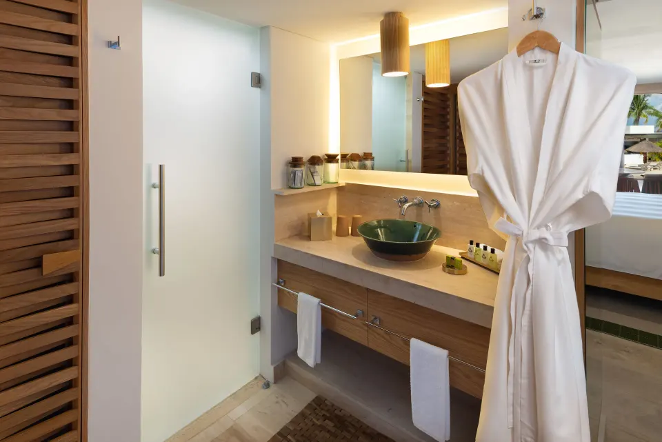 Bathroom vanity and robe in a Premium Room Ocean View at InterContinental Presidente Cozumel Resort Spa