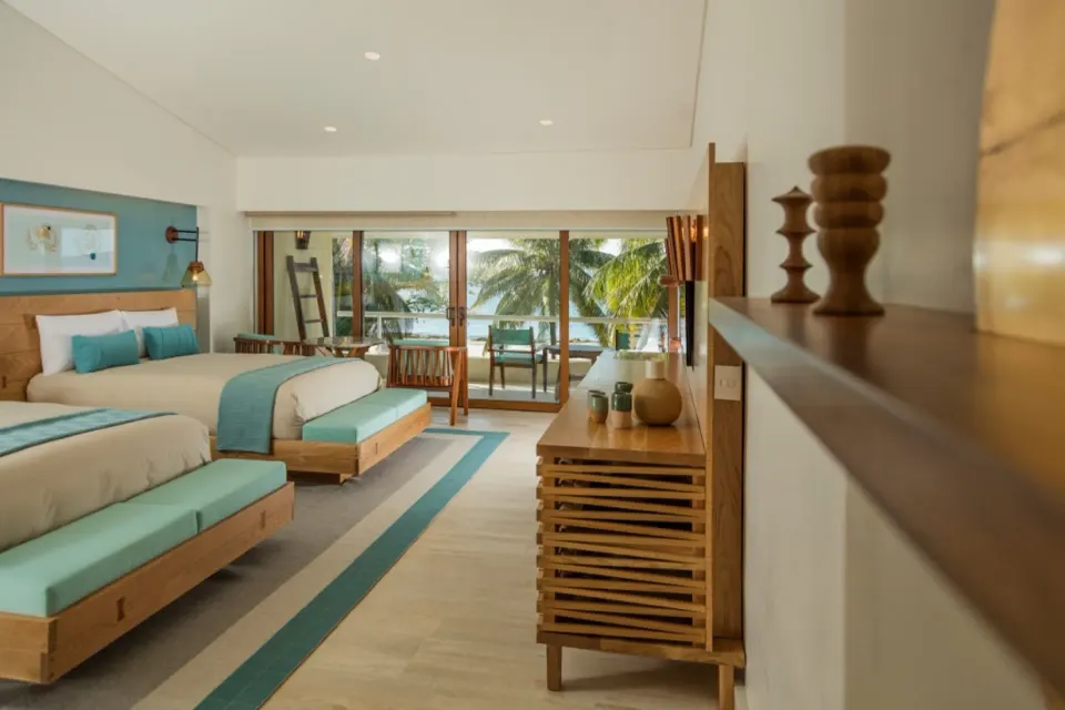 Twin beds and dresser with decor in Premium Ocean View room at InterContinental Presidente Cozumel Resort Spa
