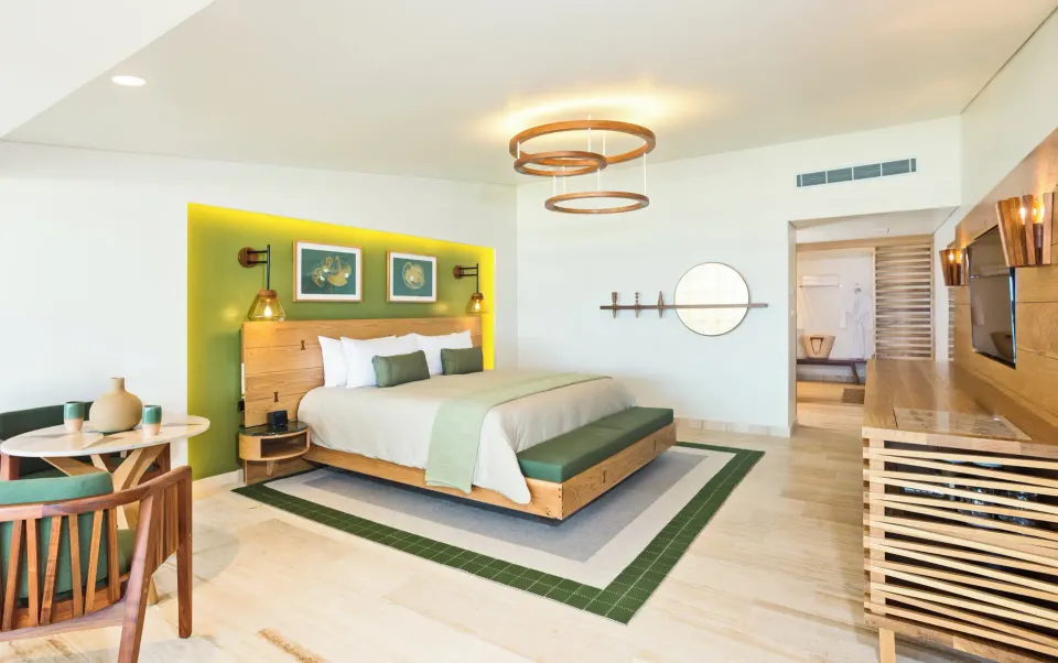 Bright king-bed Premium Room Pool Access with green headboard accent at InterContinental Presidente Cozumel Resort Spa