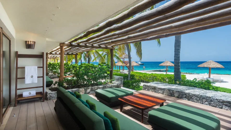 Shaded beachfront terrace with loungers and ocean view at InterContinental Presidente Cozumel Resort Spa