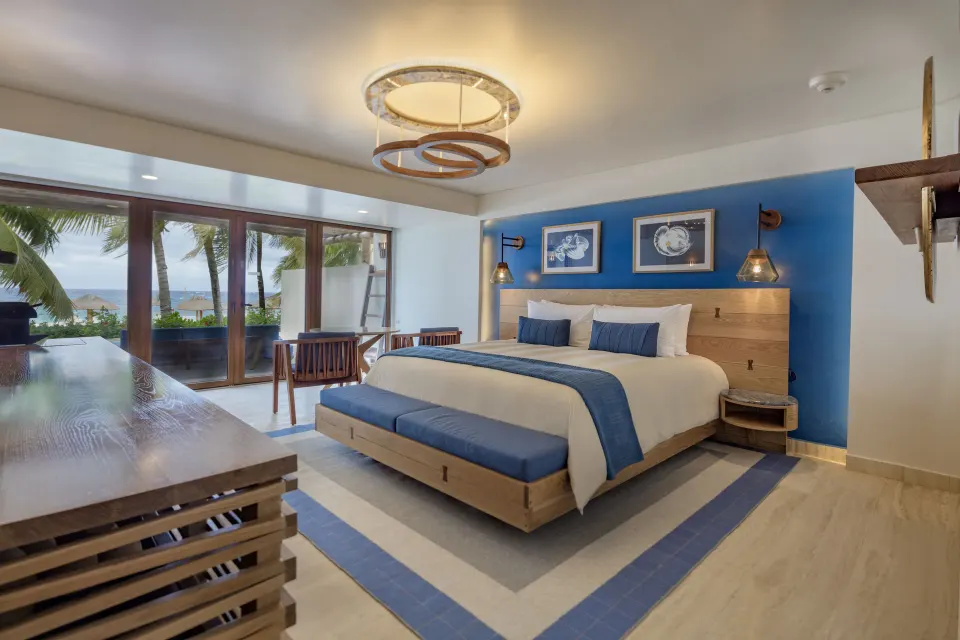 Premium Room king bed with blue accents and ocean view at InterContinental Presidente Cozumel Resort Spa