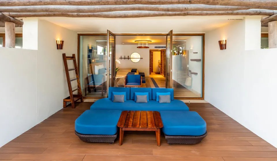 Private terrace with blue lounge seating opening into a Premium Room at InterContinental Presidente Cozumel Resort Spa