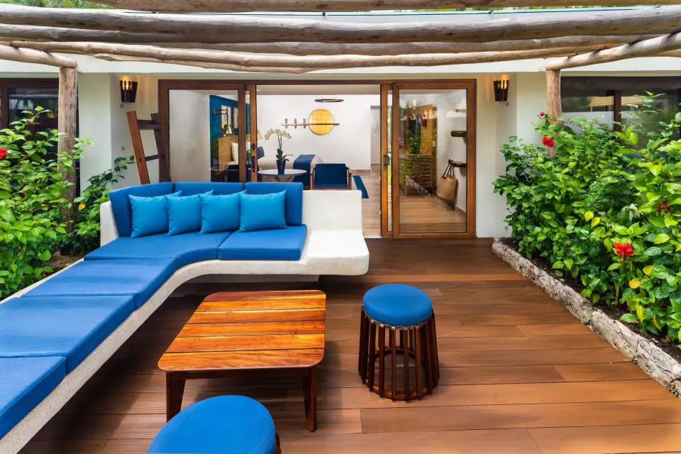 Private terrace with blue cushioned seating overlooking garden at InterContinental Presidente Cozumel Resort Spa