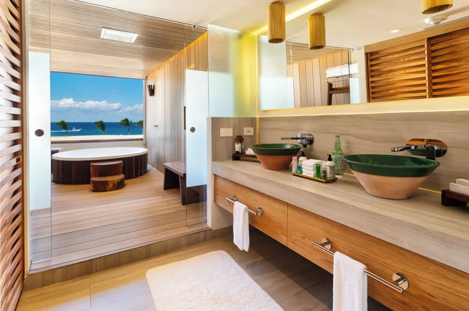 Suite bathroom with double vanity and outdoor soaking tub with ocean view at InterContinental Presidente Cozumel Resort Spa