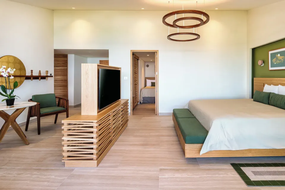 Spacious suite interior with king bed and seating at InterContinental Presidente Cozumel Resort Spa