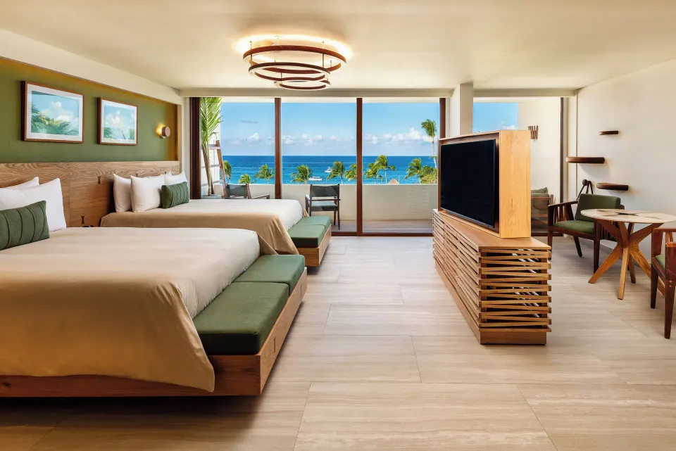 Ocean-view two-bed suite with balcony and TV console at InterContinental Presidente Cozumel Resort Spa