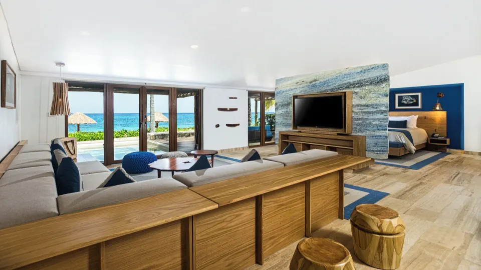 Spacious Reef Beach Access suite living area and bed with ocean view at InterContinental Presidente Cozumel Resort Spa