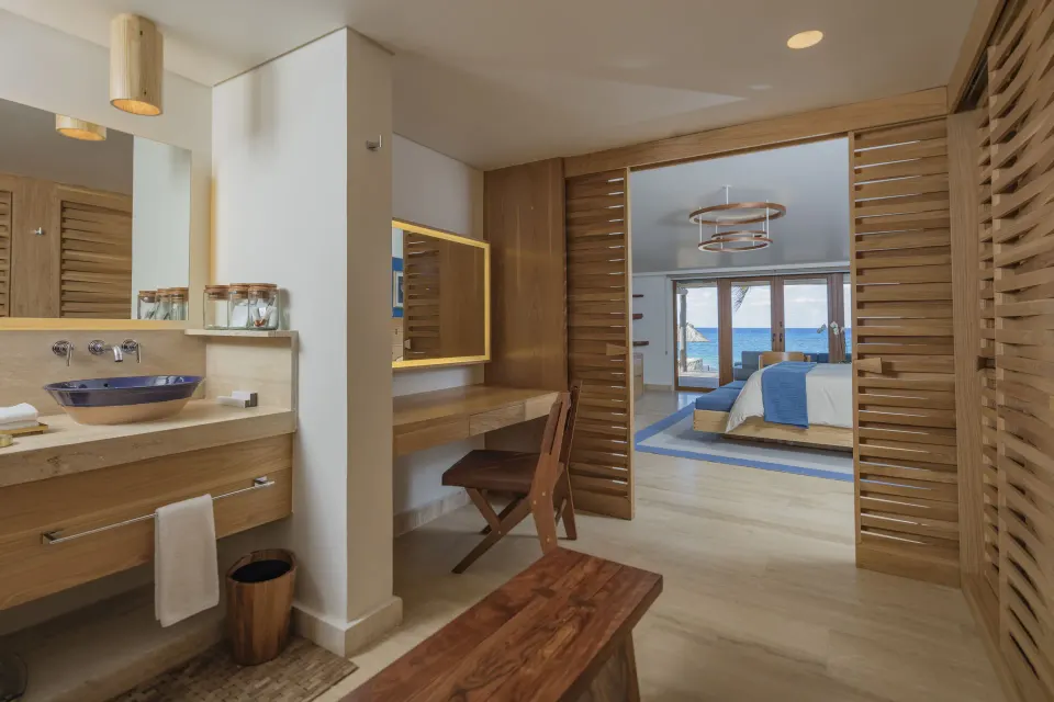 Bathroom and entry to bedroom with king bed and sea view in a Reef Beach Access Suite at InterContinental Presidente Cozumel