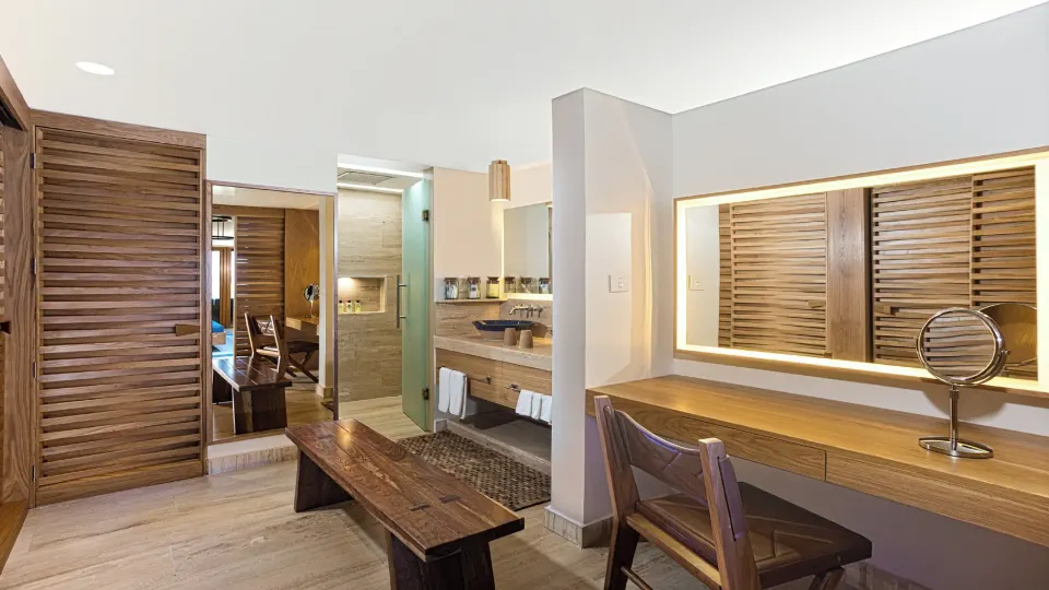 Vanity and sink area with wood shutters in a Reef Beach Access Suite at InterContinental Presidente Cozumel Resort Spa